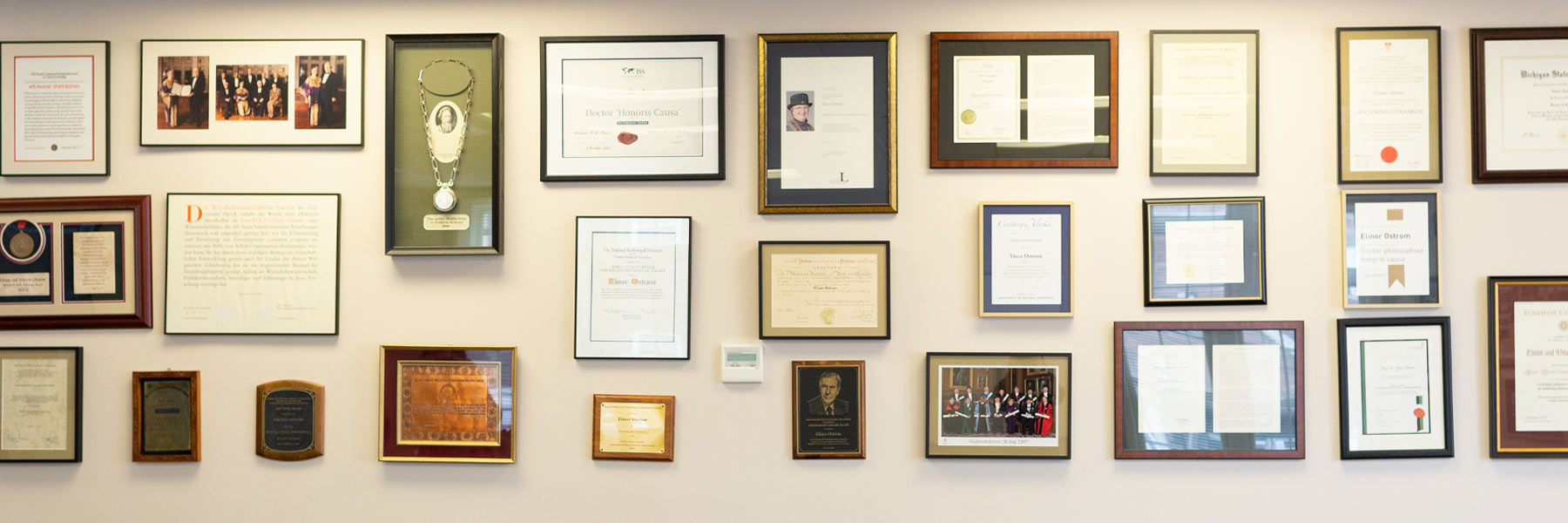 A wall of awards, framed, decorate the Ostrom Workshop. 